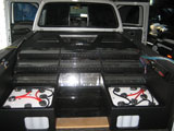 Sound system amplifiers in bed of vehicle