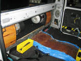 Vehicle cab showing door panel with applied Acoustiblok